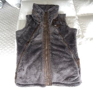 Olive colored Kühl sherpa vest with expandable hood